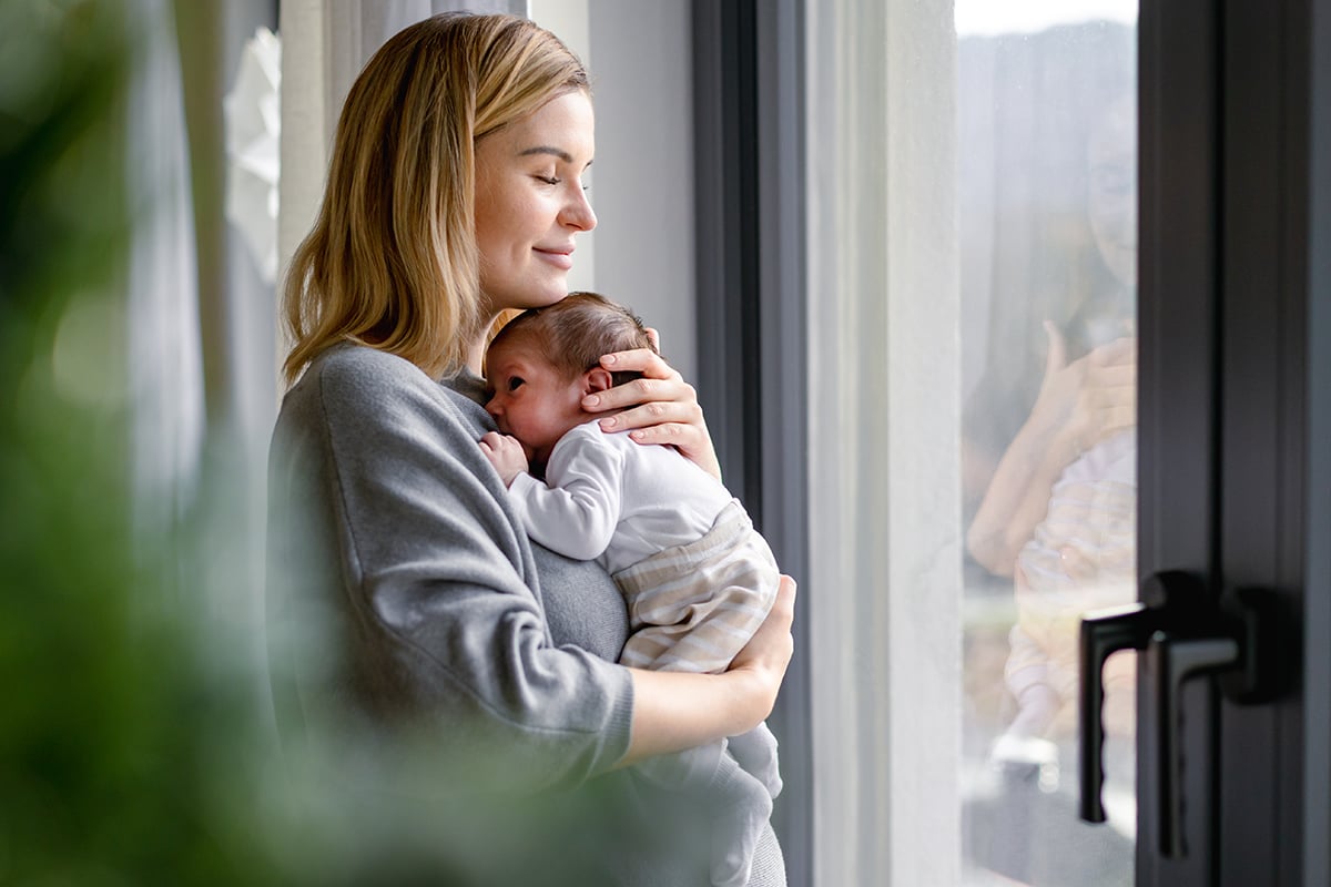 loving mother hugs her little baby at home loving mother hugs her little baby at home