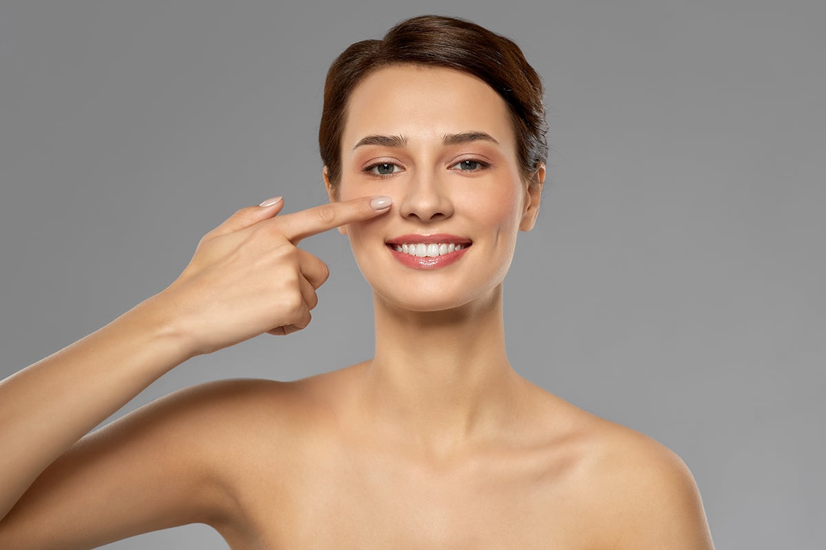 beautiful young woman showing her nose beautiful young woman showing her nose