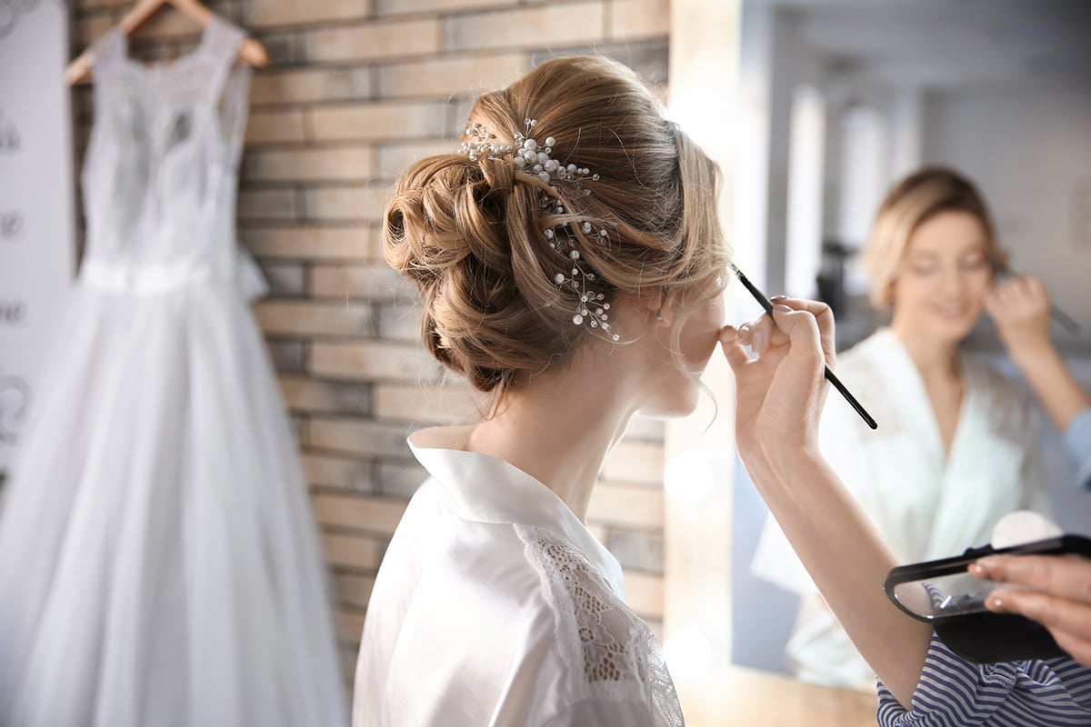 makeup artist preparing bride before her wedding in room makeup artist preparing bride before her wedding in room