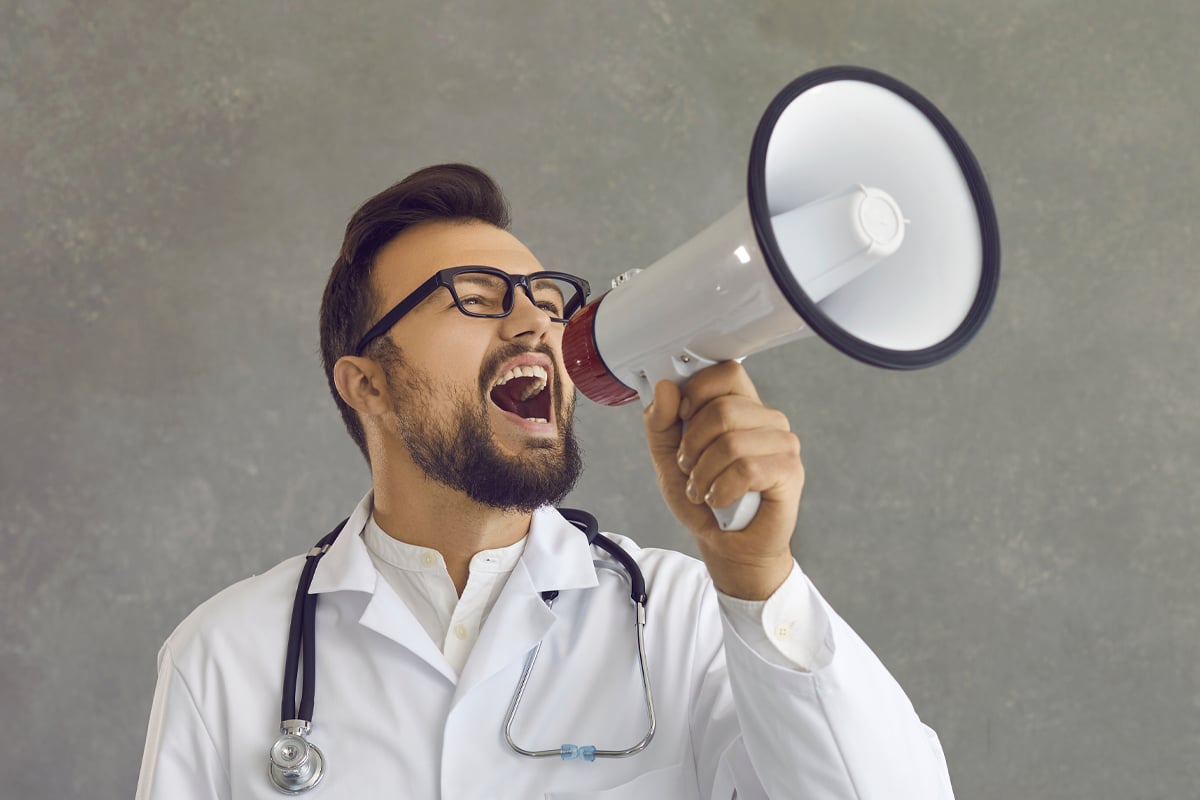 male doctor screaming shouting in megaphone to message heard male doctor screaming shouting in megaphone to message heard