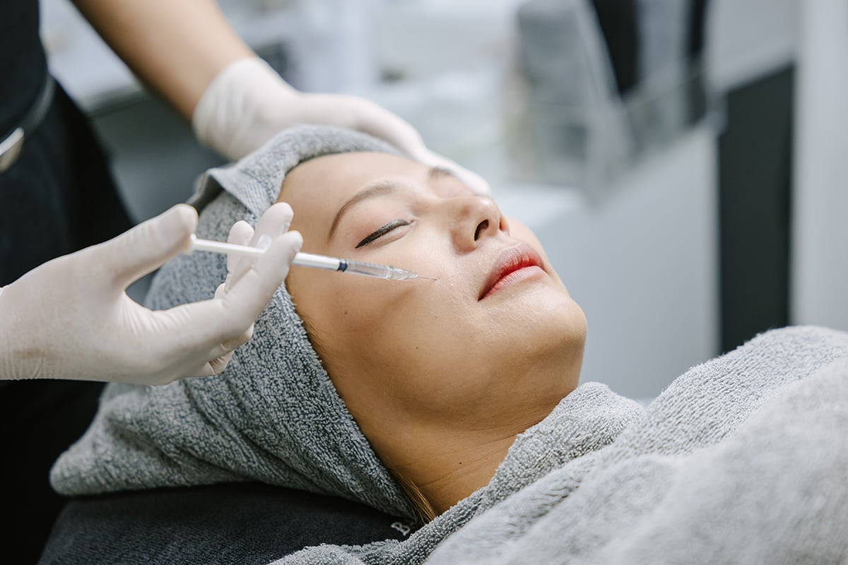 skin doctor injecting filler at woman face skin for facial treatment skin doctor injecting filler at woman face skin for facial treatment