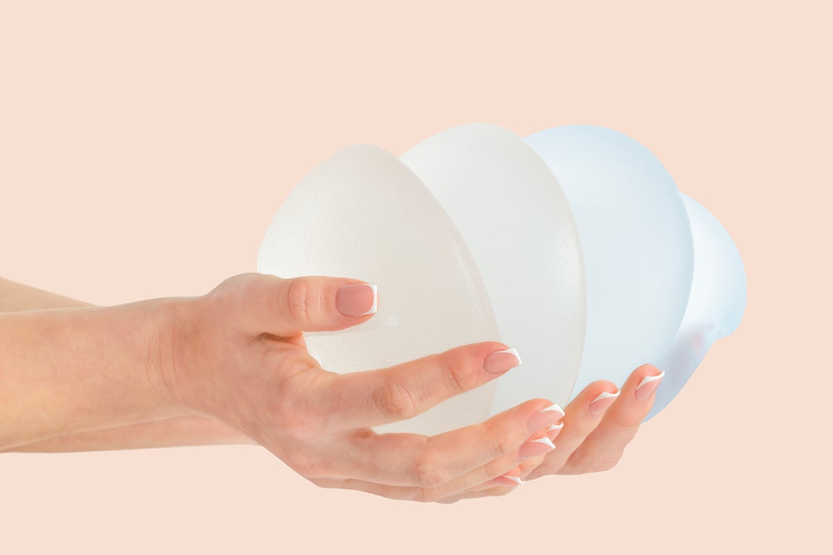 stack of different types of breast implants in hands stack of different types of breast implants in hands