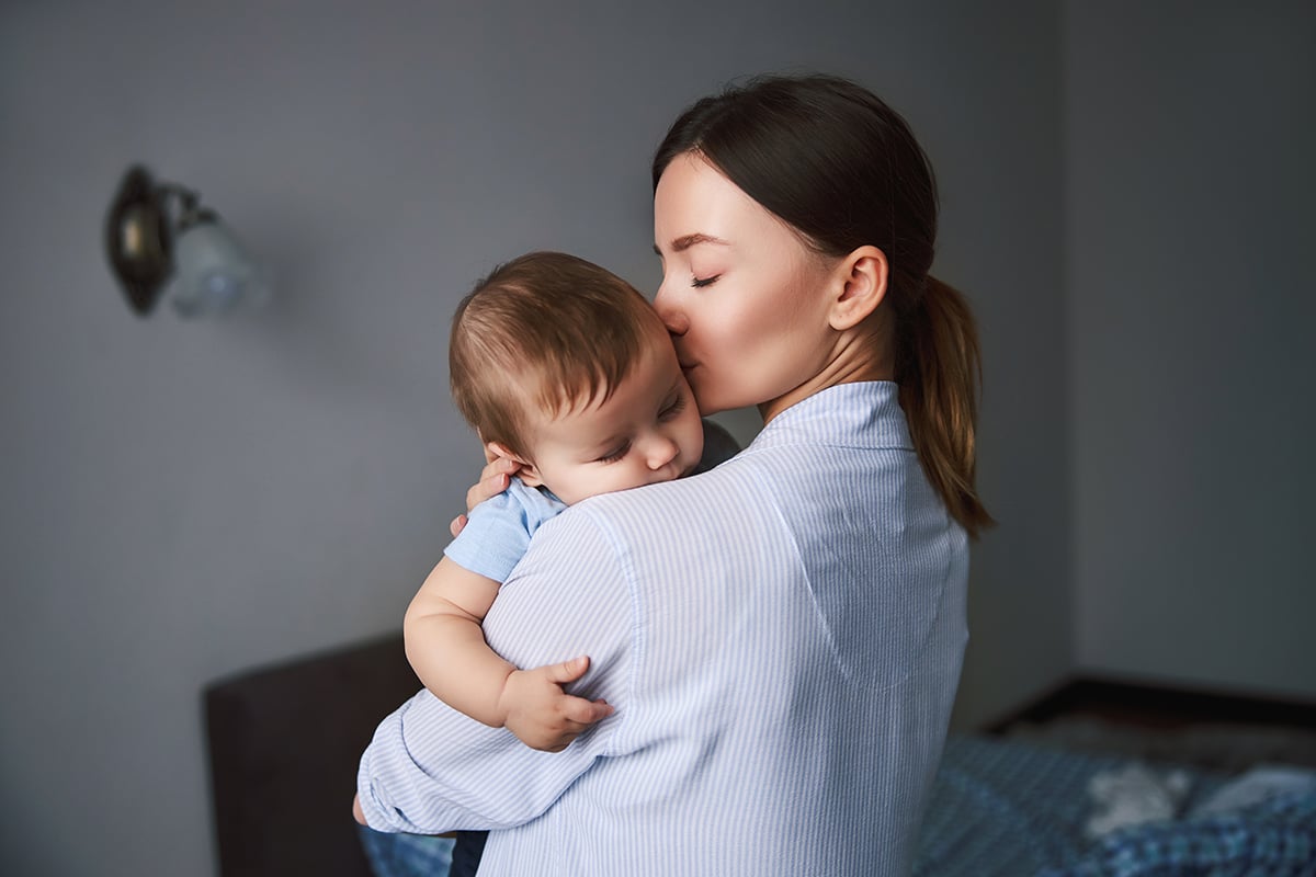 tender young woman taking care of her son tender young woman taking care of her son