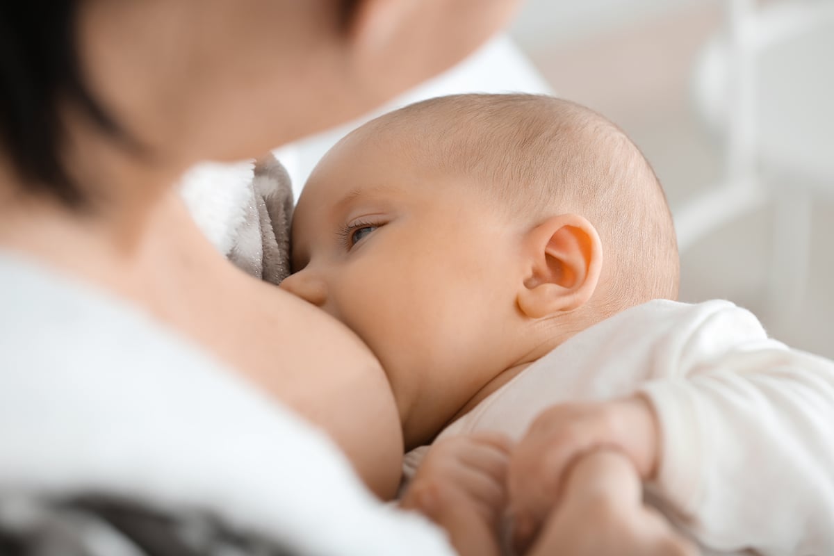 woman breastfeeding her baby closeup woman breastfeeding her baby closeup