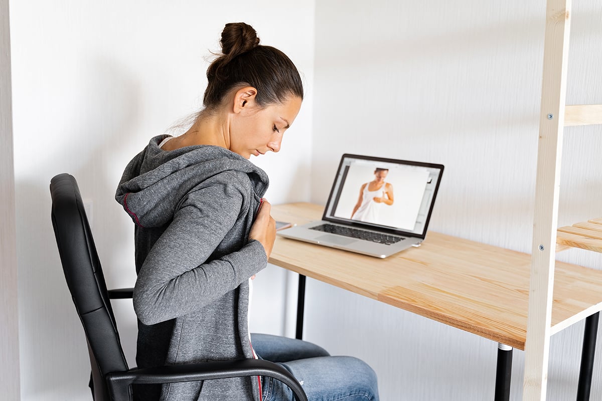 woman doing self breast check up by online tutorial woman doing self breast check up by online tutorial