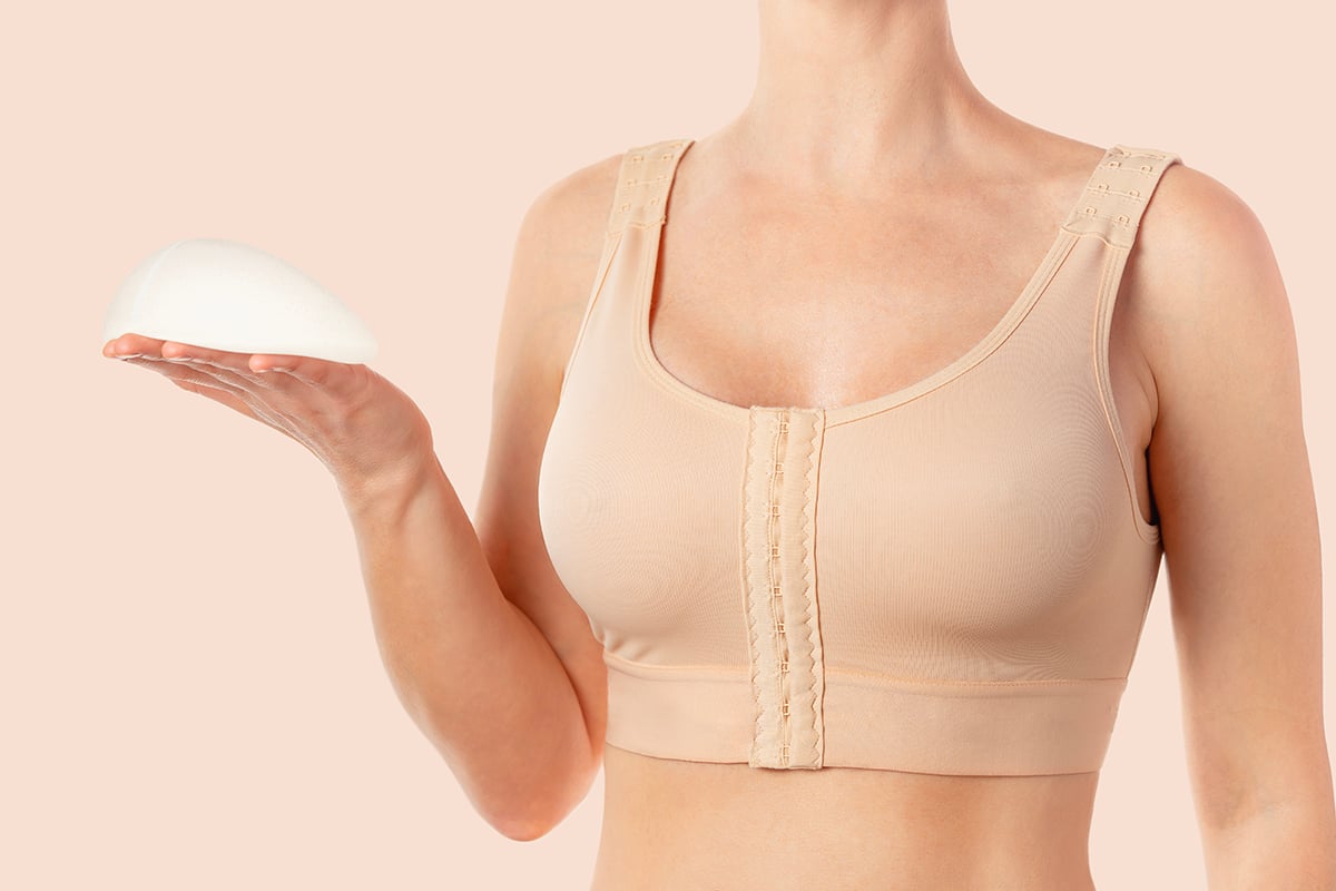 woman wearing compressing bra after breast augmentation woman wearing compressing bra after breast augmentation